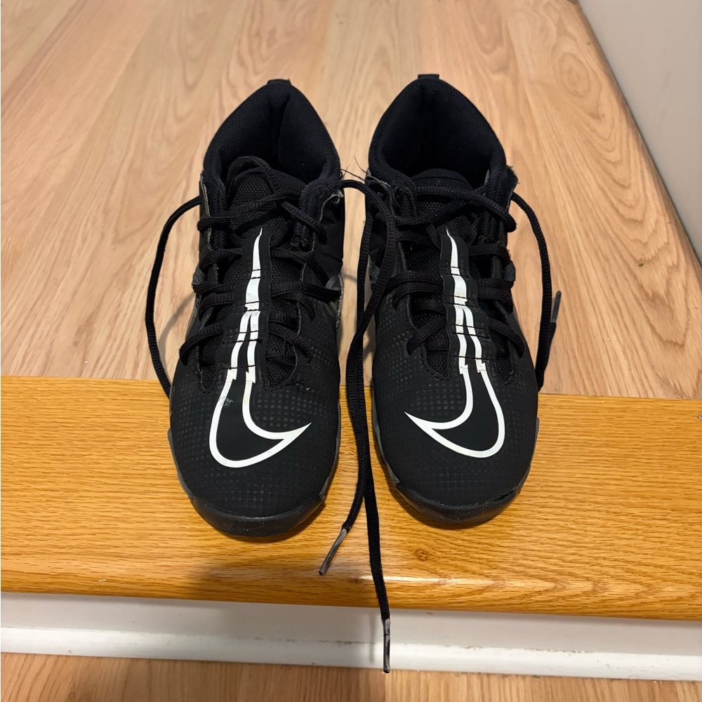 Nike Kids Black Cleats with White Swoosh